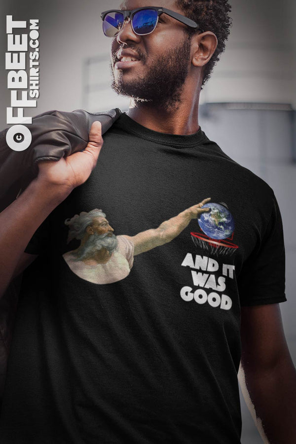 God discovers basketball No.3 Men’s Graphic T-shirt A play on creation, God discovers basketball and it was good. Graphic of gods hand bouncing earth - type saying “and it was good” (Michelangelo’s hand of god). Mens black t-shirt  I  © 2019 Offbeet Shirts original design