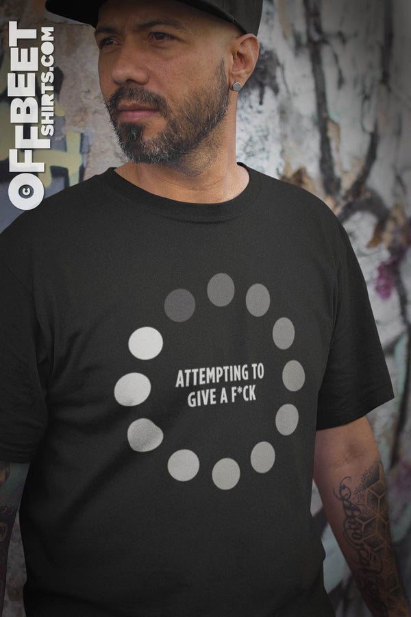 Attempting to give a F*ck Men’s Graphic T-shirt. Abit of satire for the impatient person in all of us. Circular internet video loading light to dark dots. Text: Attempting to Give a f*ck, Fuck Men’s Black t-shirt  I  © 2019 Offbeet Shirts original design