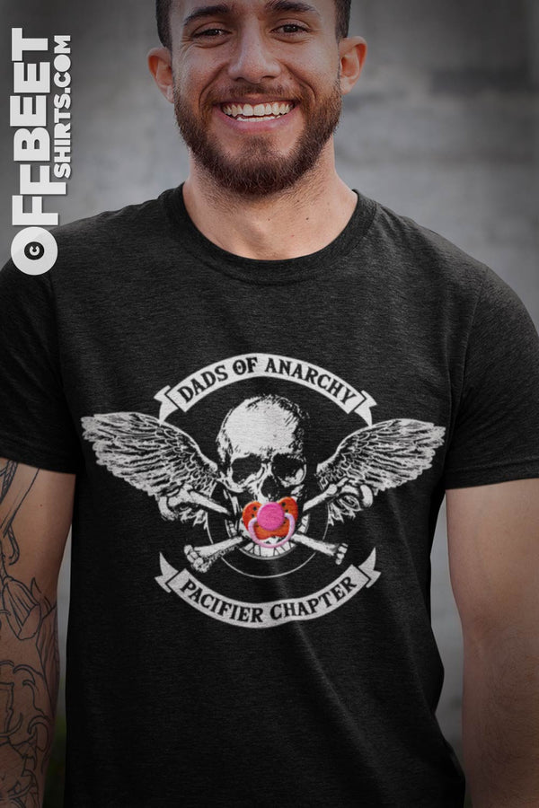 DADS OF ANARCHY, PACIFIER CHAPTER FUNNY Men's GRAPHIC T-SHIRT shows pacifier over skulls mouth, skull and cross bones motobike wheel and angels wings