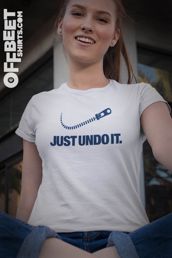 Just undo it. Zipper Swish Women’s Graphic T-shirt. Featuring zipper swish graphic. We all love the classic Nike brand, this is a playful take on the famous brand positioning.  White Mens or Womens t-shirt. ©Offbeet Shirts.