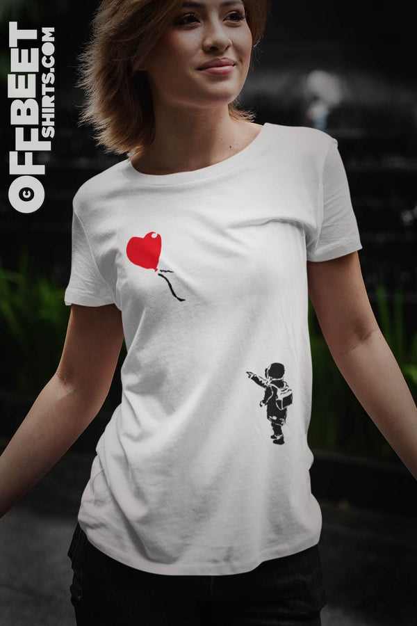 Not again - heart balloon Women’s graphic T-Shirt, a light hearted Banksy inspired composition - so cute. Red balloon shaped heart flying away from small child reaching out to to lost balloon. Black and red graphic on white t-shirt. ©Offbeet Shirts.