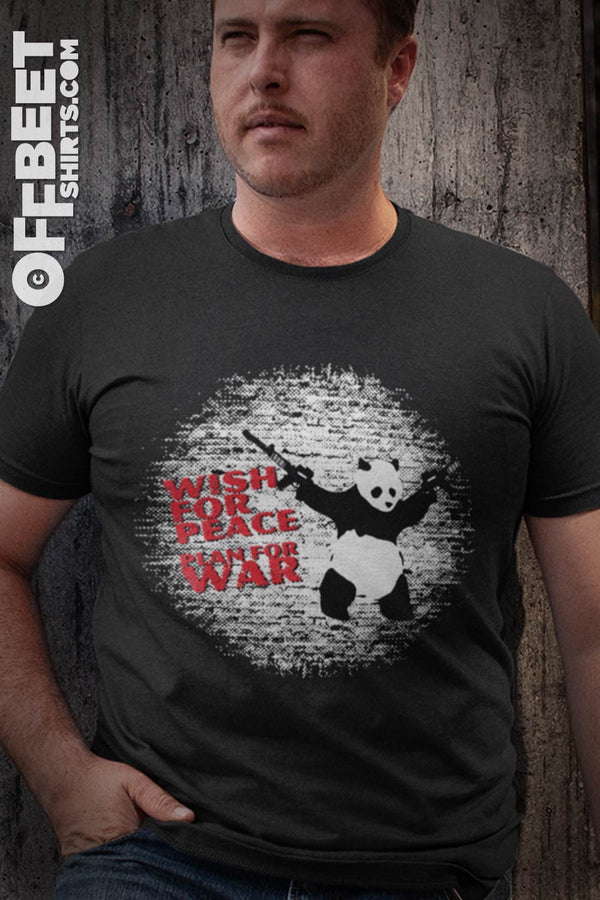 Wish for peace plan for war Men’s Graphic T-shirt. white graphic of panda with AK47s in both hands against a stylised brick wall text:Wish for peace plan for war. Mens black t-shirt  I  © 2019 Offbeet Shirts original design