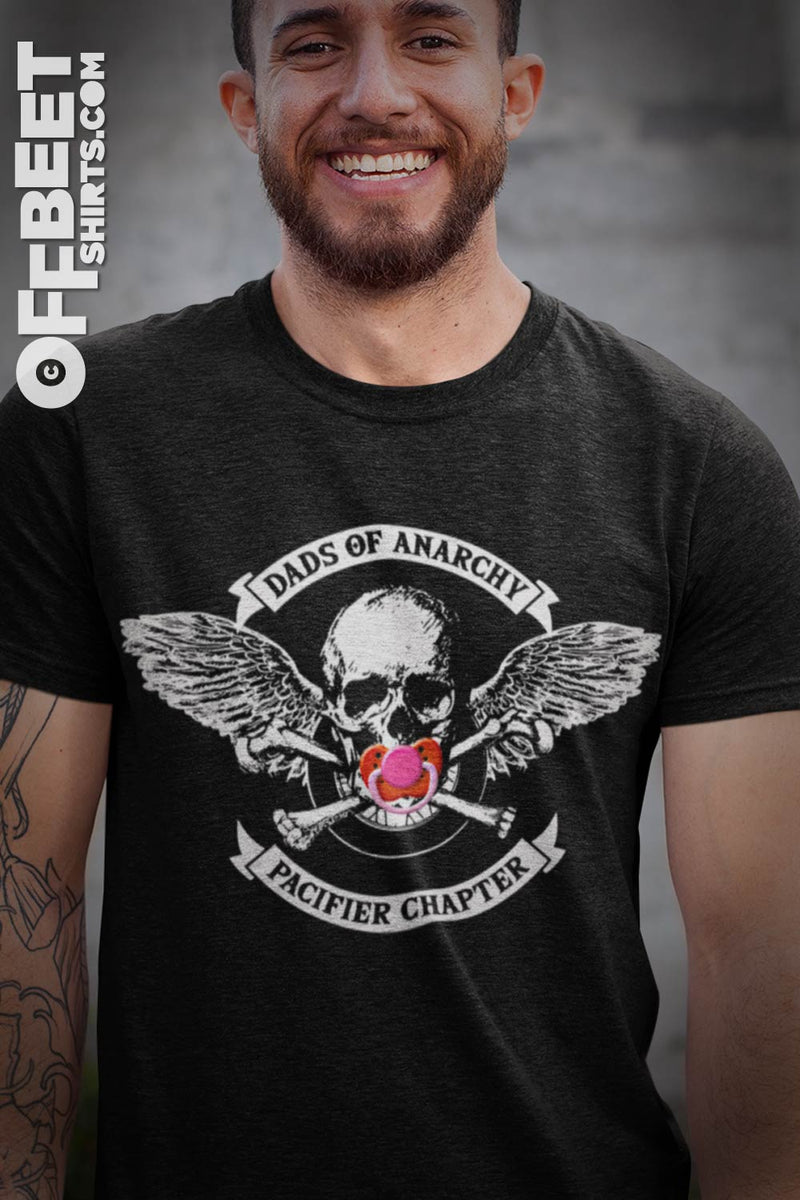 DADS OF ANARCHY, PACIFIER CHAPTER FUNNY Men's GRAPHIC T-SHIRT shows pacifier over skulls mouth, skull and cross bones motobike wheel and angels wings